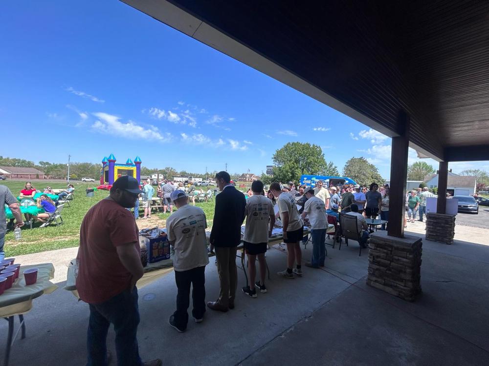 Alpha Omega Chapter brothers served food to community members who came to participate in their event.