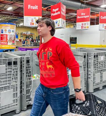 Festively dressed ELC Doug Krenzer carries emptied crate