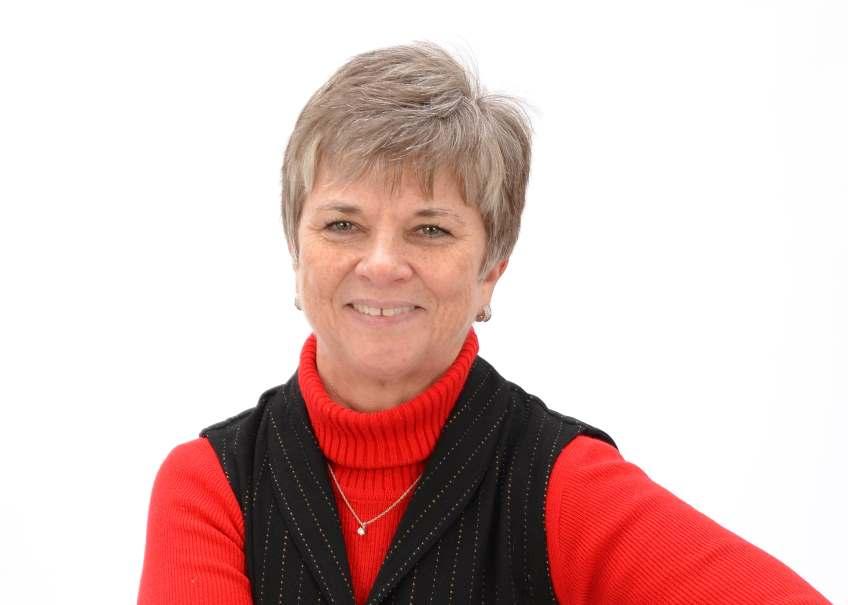 Judy Schmuecker smiling while seated